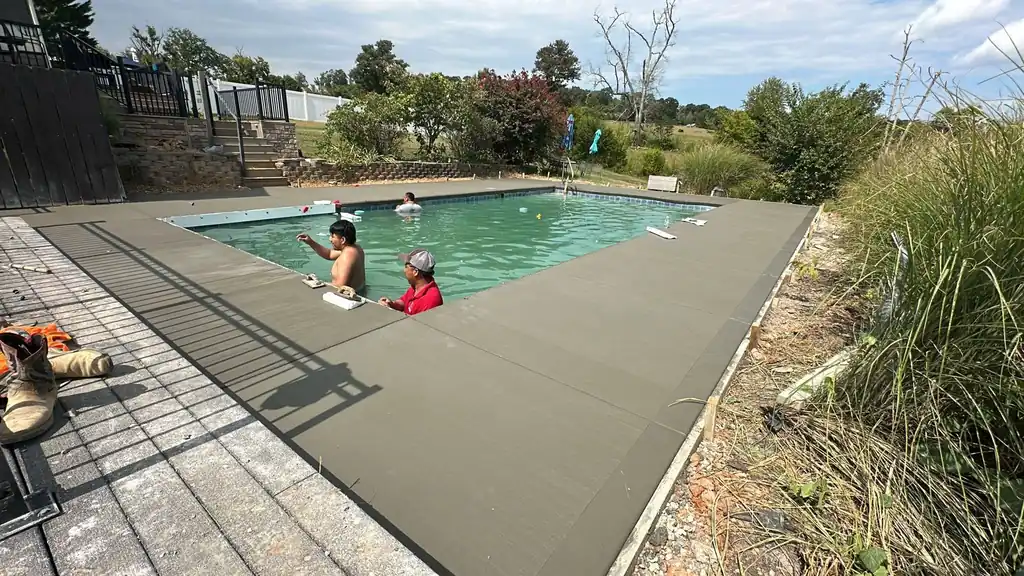Finished concrete pool deck around an inground pool in Knoxville, Tennessee
