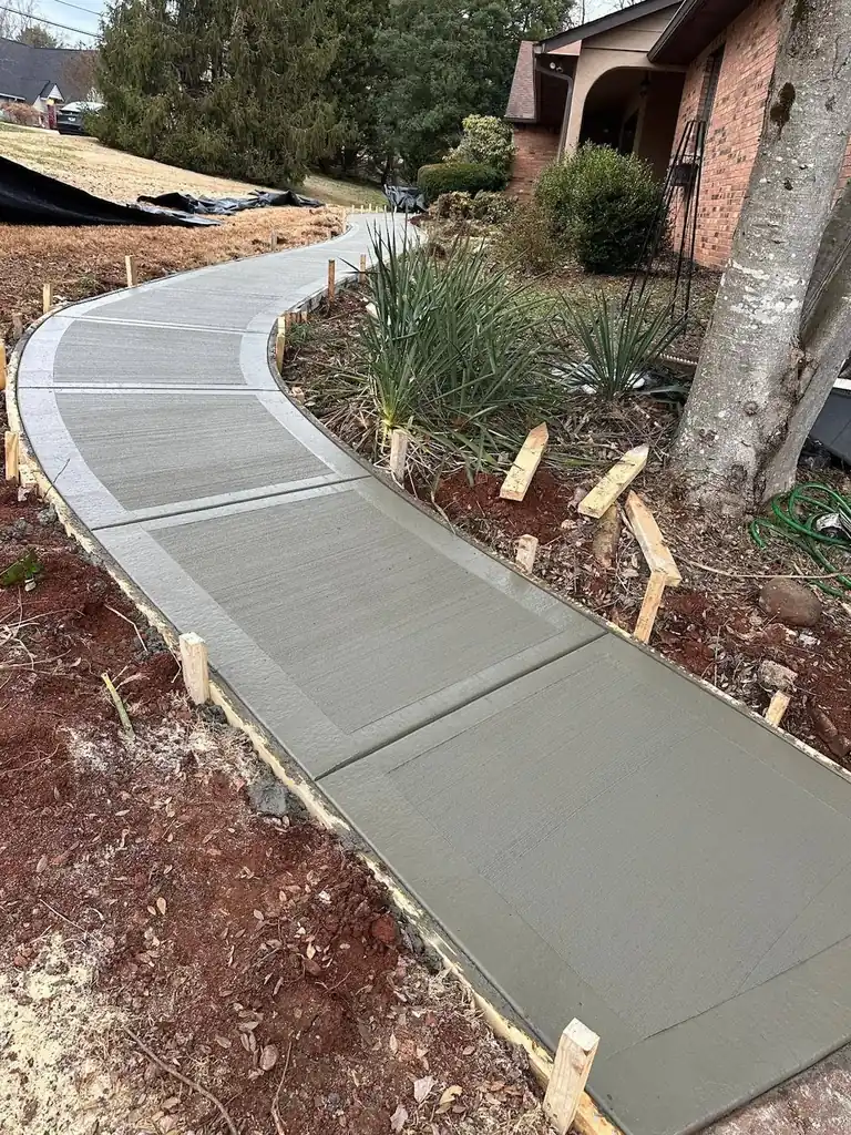 Curved concrete walkway leading to a brick home in Knoxville, Tennessee