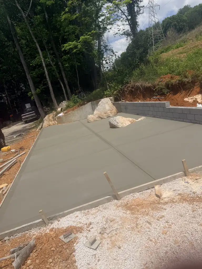 Block retaining wall built around a fresh concrete slab in Knoxville, Tennessee