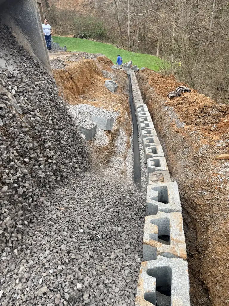 Drainage stone backfilled behind a new block retaining wall in Knoxville, TN